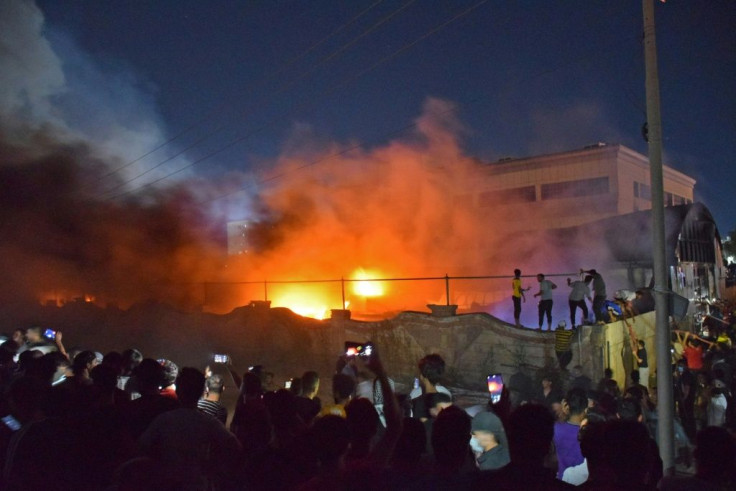 A crowd watches on as fire engulfs the Covid isolation unit of Al-Hussein hospital in the southern Iraqi city of Nasiriyah