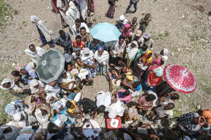 Hunger: People in the Tigrayan village of Baker wait for food being distributed on Sunday by the Amhara government