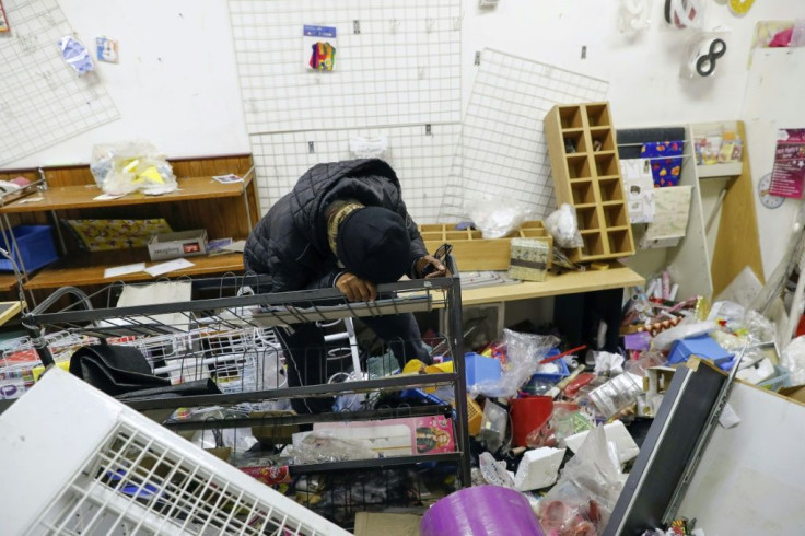 Loss: Thandi Johnson weeps inside her looted store at the Diepkloof shopping mall