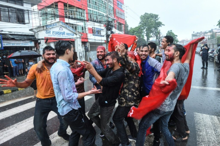 Protesters from various student wings celebrate after Nepal's Supreme Court ousted the sitting prime minister and reinstated the dissolved parliament, in Kathmandu on July 12, 2021