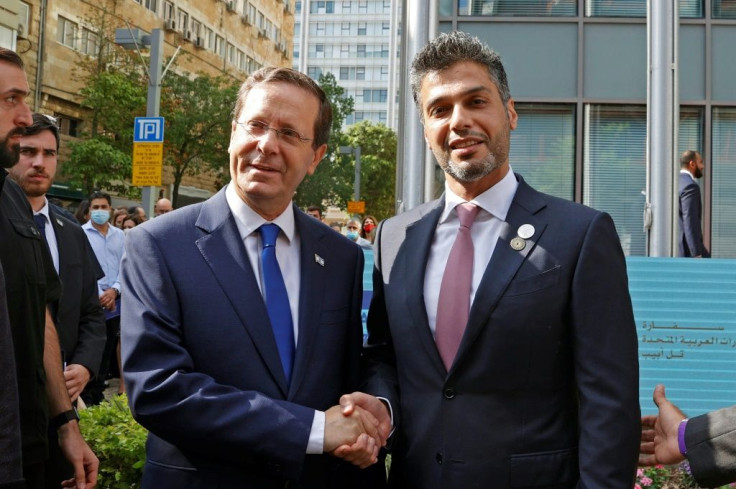 Israeli President Isaac Herzog greets the UAE's first ambassador to Israel Mohamed al-Khaja outside the new embassy in Tel Aviv's stock exchange building
