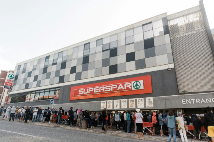 People queued to enter a supermarket in Durban on Tuesday after other stores were ransacked
