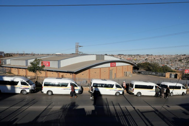 Taxi drivers block the entrance to a shopping mall in Tembisa, north of Johannesburg, in an attempt to shield it from looters