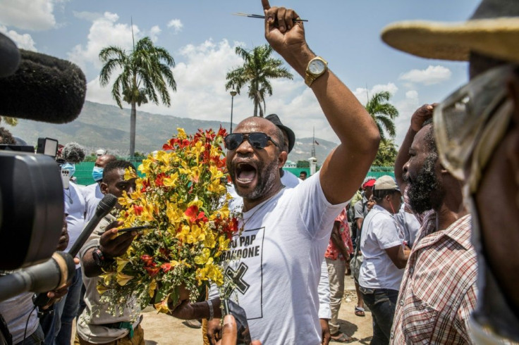 Demonstrators pray and demand justice outside of the Presidential Palace in Port-au-Prince on July 14, 2021, in the wake of Haitian President Jovenel Moise's assassination on July 7, 2021.