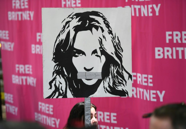 A woman holds a poster of Britney with her mouth taped shut as fans and supporters gather outside the Los Angeles County Courthouse in Los Angeles on July 14, 2021