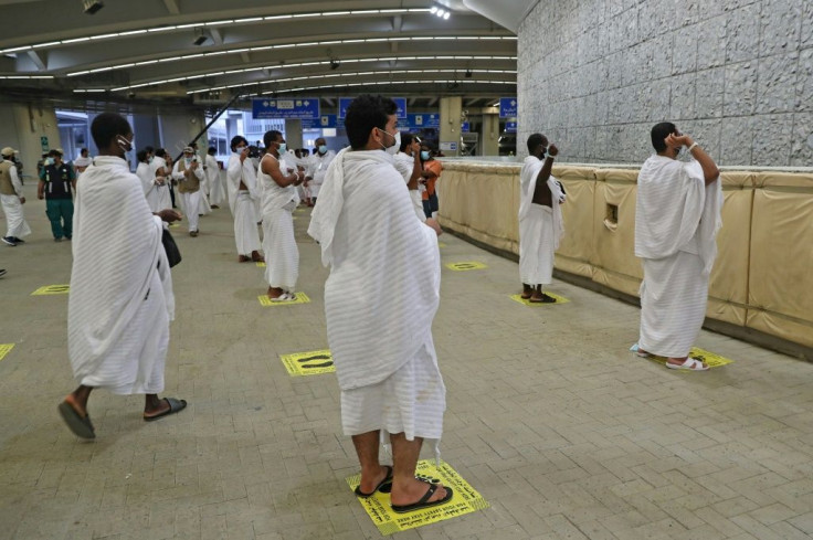 Pilgrims observing social distancing requirements at last year's hajj throw pebbles as part of the symbolic al-A'qabah (stoning of the devil ritual)