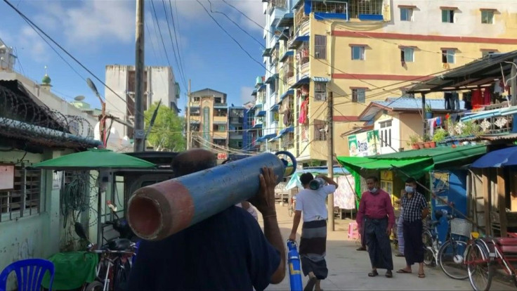 Residents across Myanmar's biggest city are defying a military curfew in a desperate search for oxygen to keep their loved ones breathing as a new coronavirus wave crashes over the coup-wracked country.