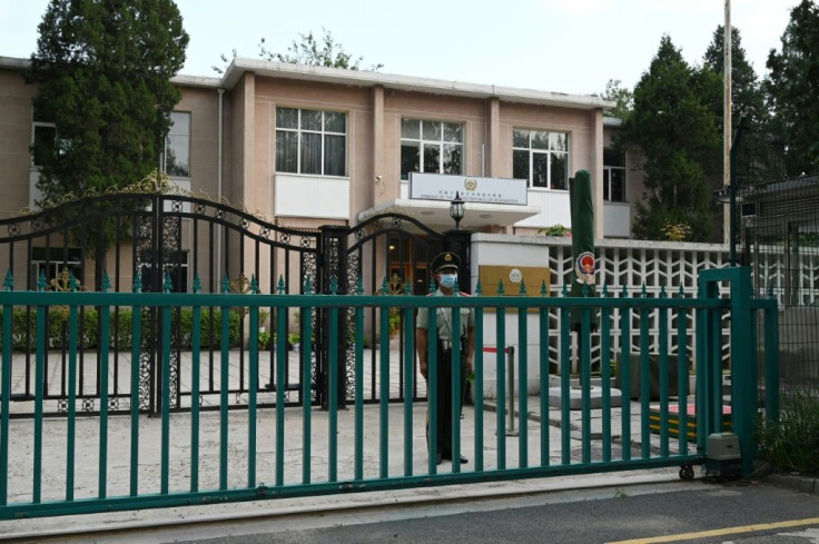 A Chinese paramilitary policeman stands guard outside the Afghanistan embassy in Beijing