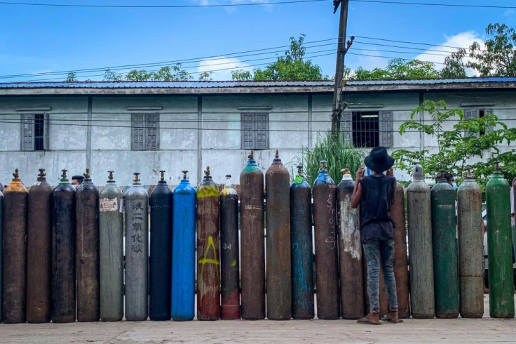 Residents across Myanmar's biggest city have defied a military curfew in a desperate search for oxygen to keep their loved ones breathing