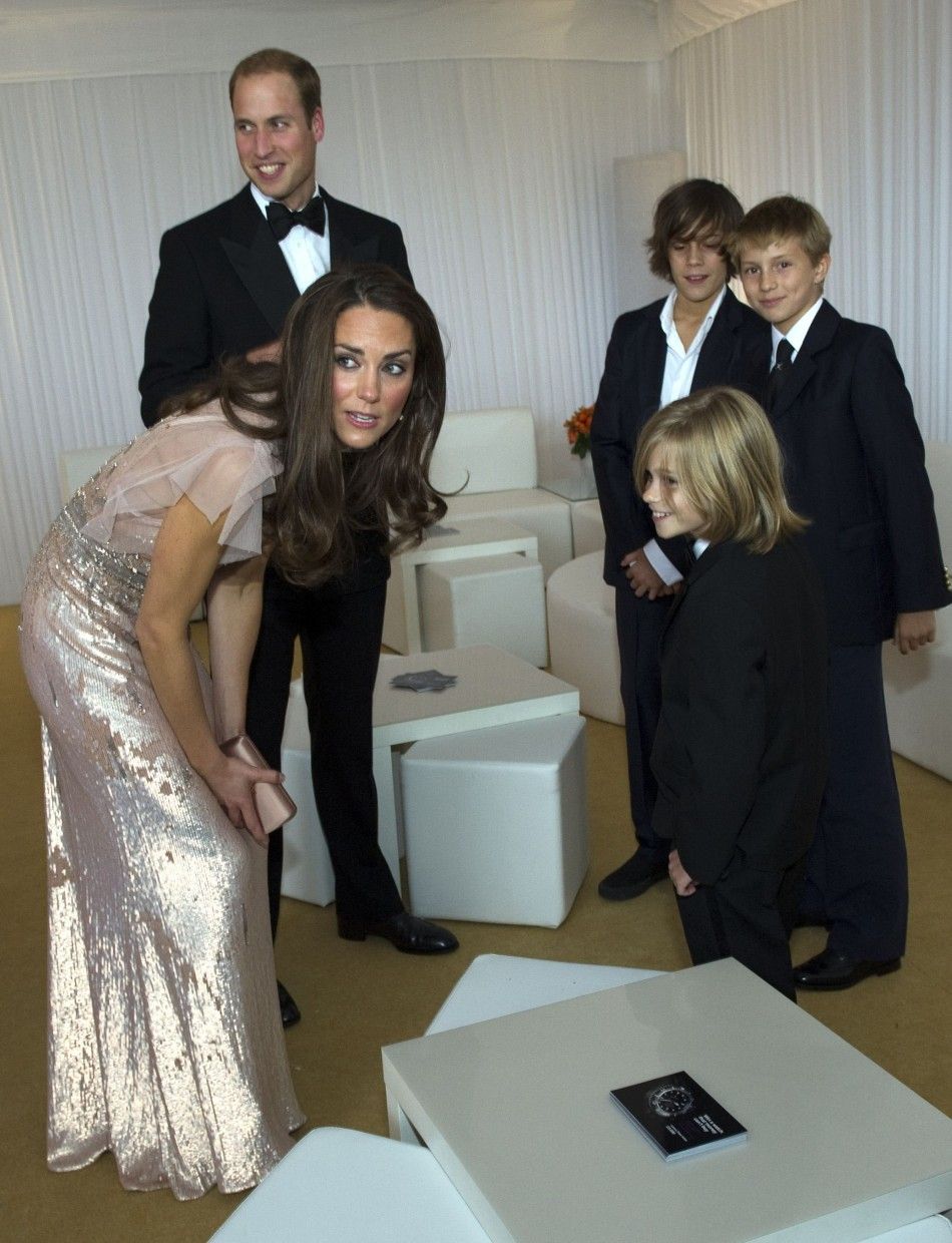 Britain039s Prince William and his wife Catherine, Duchess of Cambridge speak with children as they arrive at the10th annual ARK Absolute Return for Kids gala dinner at Kensington Palace in London June 9, 2011.