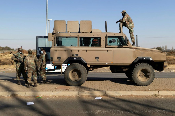 Reinforcements: Troops stand guard outside the Chris Hani shopping mall in Vosloorus on the outskirts of Johannesburg
