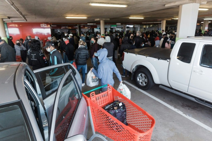 Fear of shortages: Hundreds queue to buy food at a supermarket in the KwaZulu-Natal city of Durban