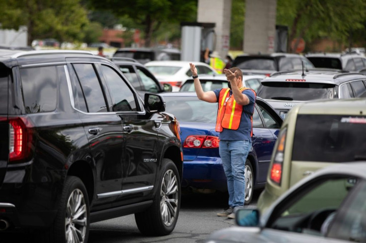 Attendants direct cars to gas pumps as they queue to fill their tanks at a Costco in Charlotte, North Carolina in May 2021 following a ransomware attack that shut down the Colonial Pipeline