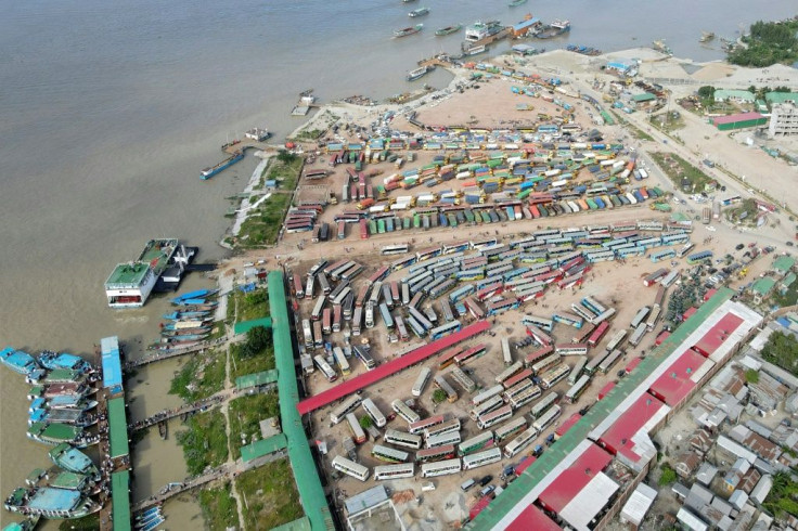 This aerial photograph taken on July 15, 2021 in Sreenagar, Bangladesh, shows vehicles waiting to get transported on ferries after the government eased a lockdown imposed against Covid-19 ahead of the Muslim festival of Eid al-Adha