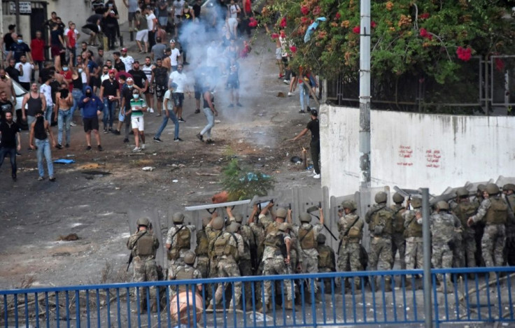 Lebanese soldiers fire rubber bullets during sporadic clashes with supporters of Lebanon's prime minister-designate Saad Hariri, who stepped down saying he was unable to form a government, in the capital Beirut on Thursday