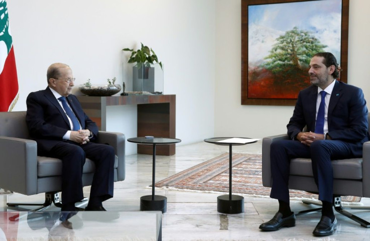 A handout picture provided by the Lebanese photo agency Dalati and Nohra on July 15, 2021, shows Lebanon's prime minister-designate Saad Hariri meeting with President Michel Aoun at the presidential palace in Baabda, east of the capital Beirut