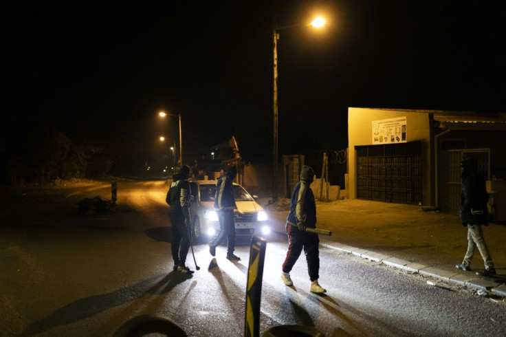 Vigilantes: Community members mount a road block in Phoenix Township. Twenty people have died in clashes