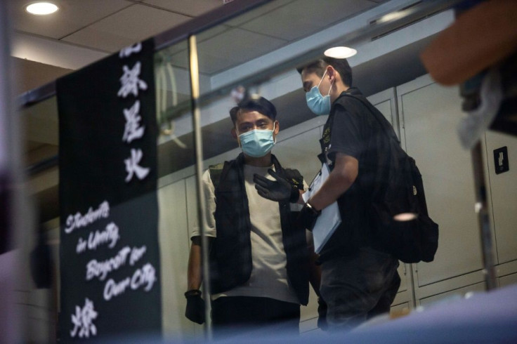 National security police are seen inside the University of Hong Kong's student union building Friday