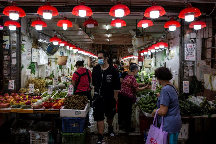 People shop at a fruit and vegetable store in Hong Kong
