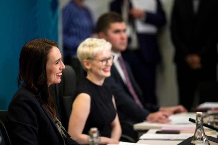 New Zealand's Prime Minister Jacinda Ardern (L) chairing the APEC 2021 Informal Leaders' Retreat alongside APEC officials in Wellington