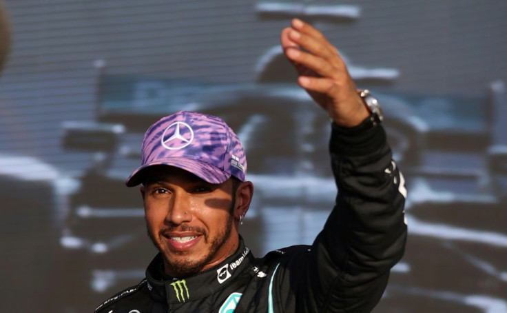 Home comfort:  Lewis Hamilton celebrates after finishing first in Friday qualifying at Silverstone