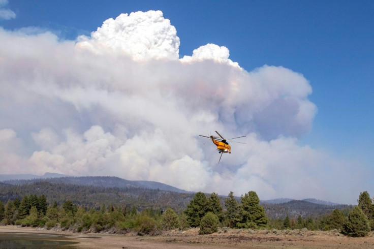 Helicopters loaded with water flew over the Bootleg Fire, 27 miles northeast of Klamath Falls, near Bly, Oregon