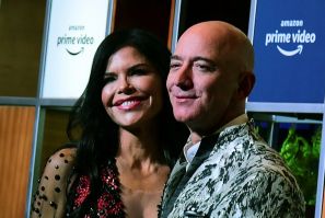 Jeff Bezos and his girlfriend Lauren Sanchez pose for pictures as they arrive to attend an event in Mumbai on January 16, 2020