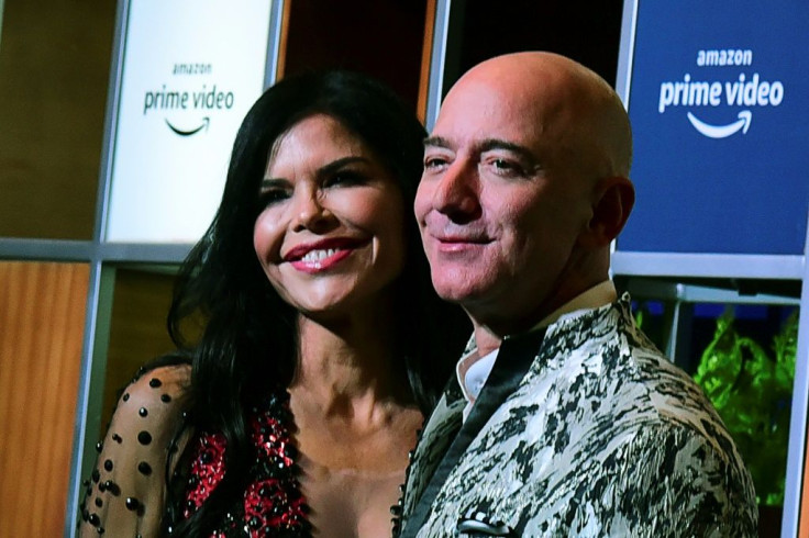 Jeff Bezos and his girlfriend Lauren Sanchez pose for pictures as they arrive to attend an event in Mumbai on January 16, 2020