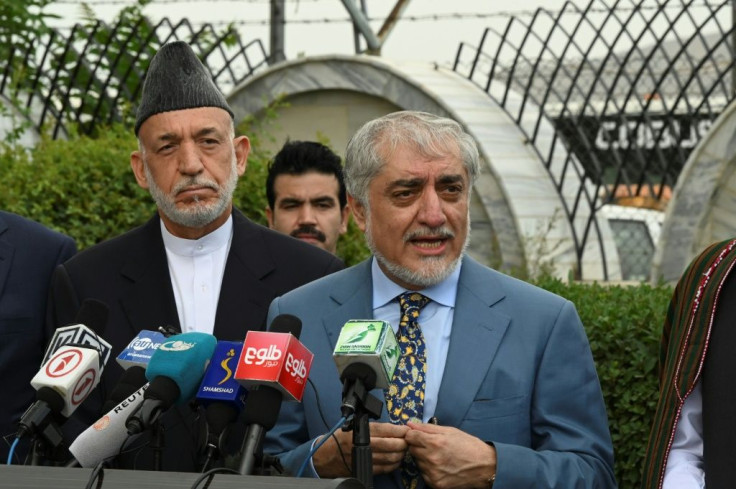 Former Afghan chief executive Abdullah Abdullah (C) and former Afghan president Hamid Karzai (L) will be part of a Kabul negotiating team due to hold talks in Qatar with Taliban delegates