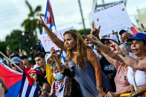 Naima Pineda gestures as she protests to show support for Cubans demonstrating against their government, in Miami, Florida.