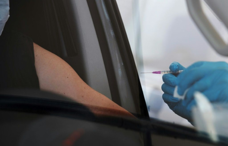 A man is vaccinated in his car at Berlin's first drive-thru vaccination center