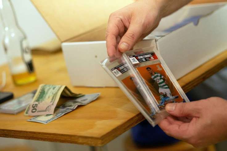 Sports card collectors strike a deal on soccer cards at Bleecker Trading in New York on July 06, 2021