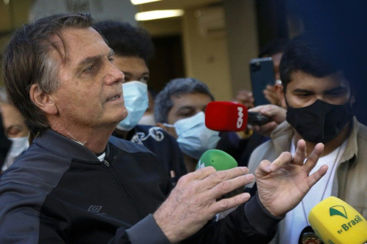 Brazil President Jair Bolsonaro speaks to the press as he leaves hospital following four days of treatment for an intestinal obstruction