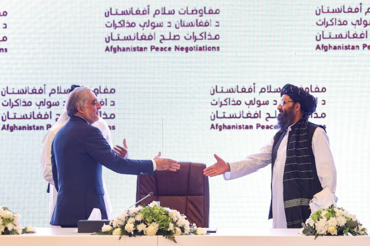 The head of Afghanistan's High Council for National Reconciliation Abdullah Abdullah (L) prepares to shake hands with the leader of the Taliban negotiating team Mullah Abdul Ghani Baradar Doha where two days of talks ended without significant progress
