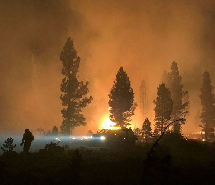 A firefighter and rig during night operations on the night of July 17 at the Bootleg Fire, near Klamath Falls, Oregon