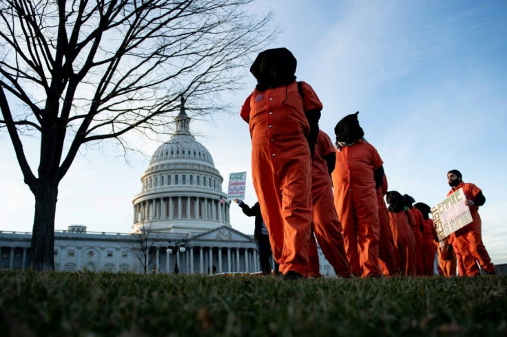 Demonstrators dressed in Guantanamo Bay prisoner uniforms march past Capitol Hill in Washington, DC, on January 9, 2020