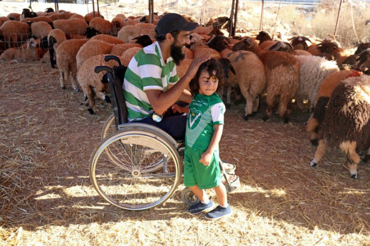 Seriously wounded in the revolt that overthrew and killed dictator Moamer Kadhafi in 2011, Osama al-Aqury uses a wheelchair as he manoeuvres easily among his animals