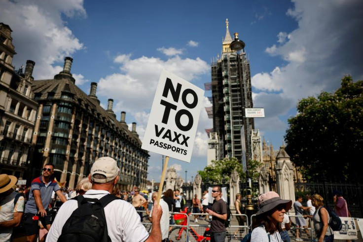 Anti-vaccination protesters gather outside the Houses of Parliament as coronavirus restrictions are lifted in England. But scientists expressed deep concern as infections. Britain will administer vaccines to clinically vulnerable youngsters.