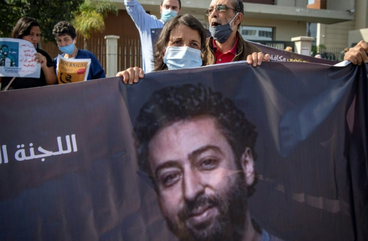 Omar Radi's mother holds a banner picture of her son at a protest in Casablanca in this file picture from September 22, 2020