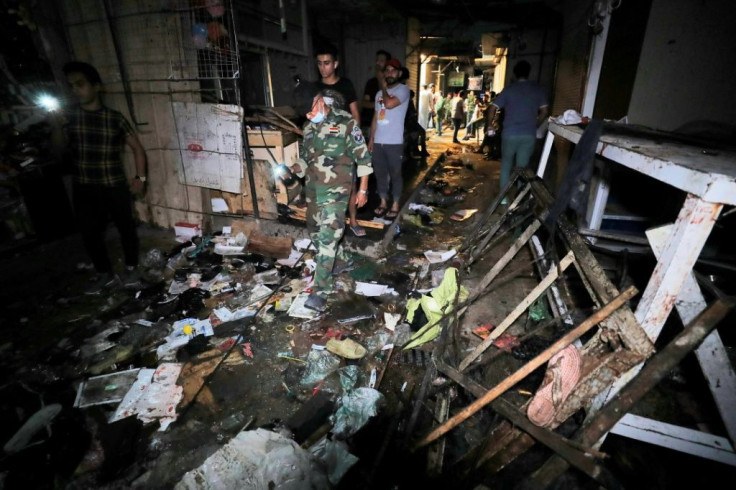 Iraqis inspect the site of the explosion in a popular market in the mostly Shiite neighbourhood of Sadr City