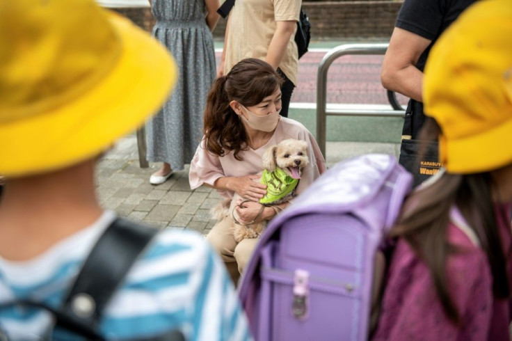 Residents of Tokyo's Karasuyama are grrrateful for the security and cuddles provides by their canine protectors