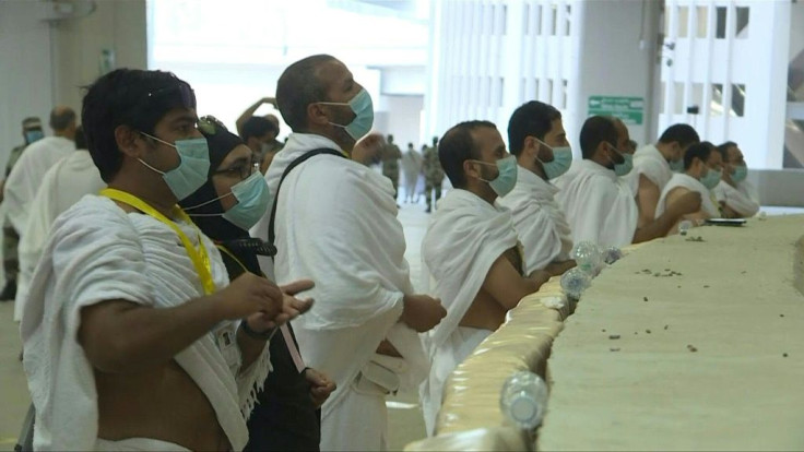 Mask-clad Muslim pilgrims throw pebbles as they "stone the devil" in the last major ritual of a scaled-back hajj due to coronavirus limits for a second year running.