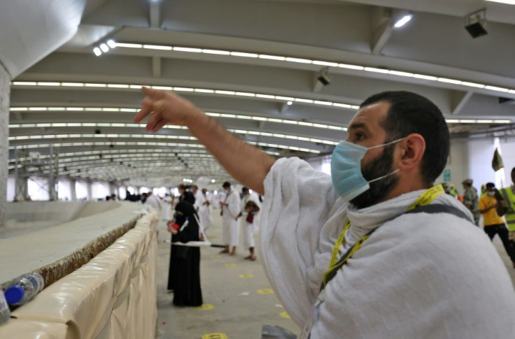A Muslim pilgrim throws pebbles at a wall symbolising the devil at the Jamrah al-Aqaba mosque outside Mecca in the last major ritual of this year's downsized hajj