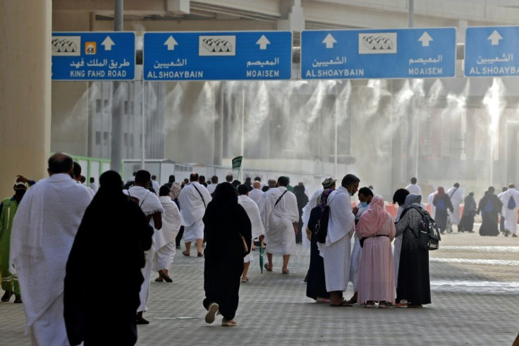 Water mist is sprayed to cool down pilgrims as they make their way around the Muslim holy places for the rituals of the hajj