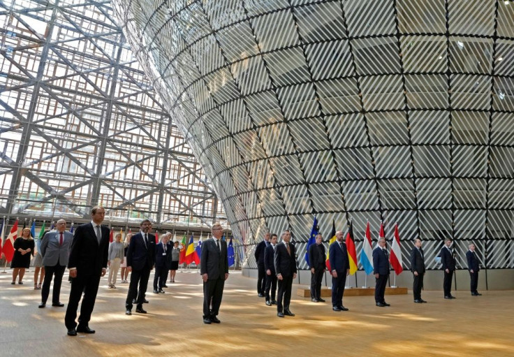 EU ambassadors stand with council president Charles Michel for one minute of silence in Brussels Tuesday