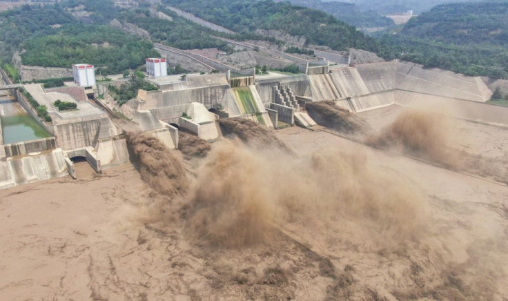 This aerial photo taken on July 5, 2021 shows water being released from the Xiaolangdi Reservoir Dam in Luoyang in China's central Henan province, which has been hit by severe storms and torrential rain