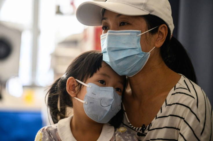 Rainbow (R) has capped her household's daily food bill at HK$100 but does her best to make sure her daughters still eat healthily