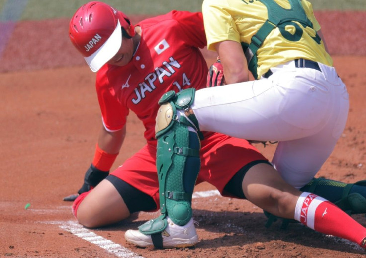 Minori Naito (L) slides to safety as Japan beat Australia 8-1