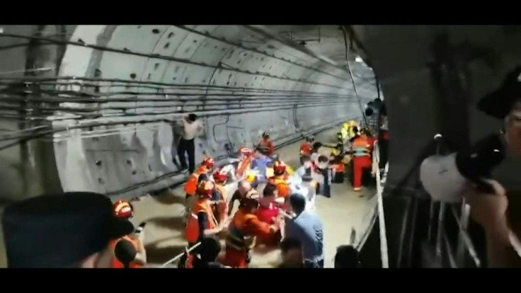 Firefighters rescue trapped passengers from a flooded subway station in the central Chinese city of Zhengzhou, where deadly torrential rains have wreaked havoc.