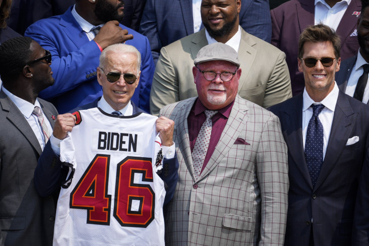 U.S. President Joe Biden holds up a Buccaneers jersey while standing next to head coach Bruce Arians and quarterback Tom Brady